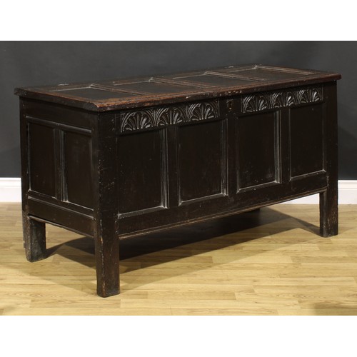 1623 - A Charles II oak four panel blanket chest, hinged top above a lunette carved frieze, stile feet, 75c... 