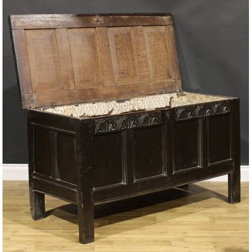 1623 - A Charles II oak four panel blanket chest, hinged top above a lunette carved frieze, stile feet, 75c... 