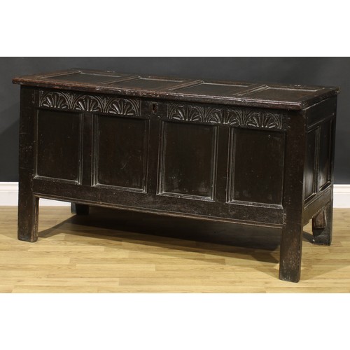 1623 - A Charles II oak four panel blanket chest, hinged top above a lunette carved frieze, stile feet, 75c... 