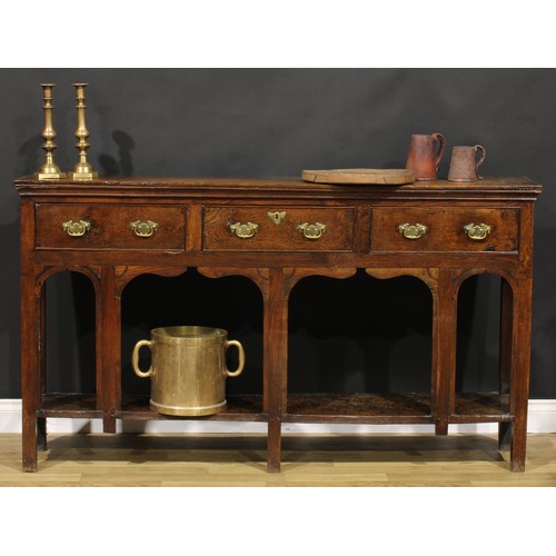 2074 - An 18th century oak low potboard dresser, of shallow proportions, rectangular top above three frieze... 