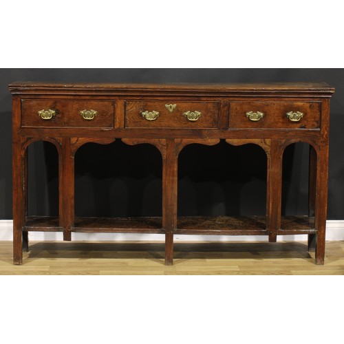 2074 - An 18th century oak low potboard dresser, of shallow proportions, rectangular top above three frieze... 