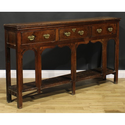 2074 - An 18th century oak low potboard dresser, of shallow proportions, rectangular top above three frieze... 