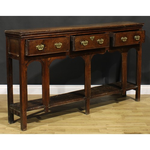 2074 - An 18th century oak low potboard dresser, of shallow proportions, rectangular top above three frieze... 