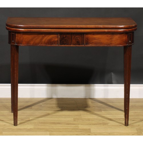 2075 - A George IV mahogany tea table, hinged top above a deep frieze centred by a rectangular tablet, tape... 