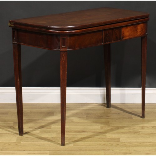 2075 - A George IV mahogany tea table, hinged top above a deep frieze centred by a rectangular tablet, tape... 