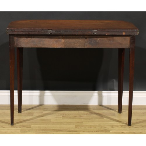 2075 - A George IV mahogany tea table, hinged top above a deep frieze centred by a rectangular tablet, tape... 