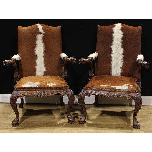 1597 - A pair of George II style mahogany Gainsborough chairs, boldly carved in the Irish Rococo taste with... 