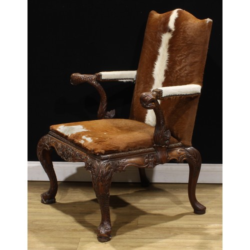 1597 - A pair of George II style mahogany Gainsborough chairs, boldly carved in the Irish Rococo taste with... 