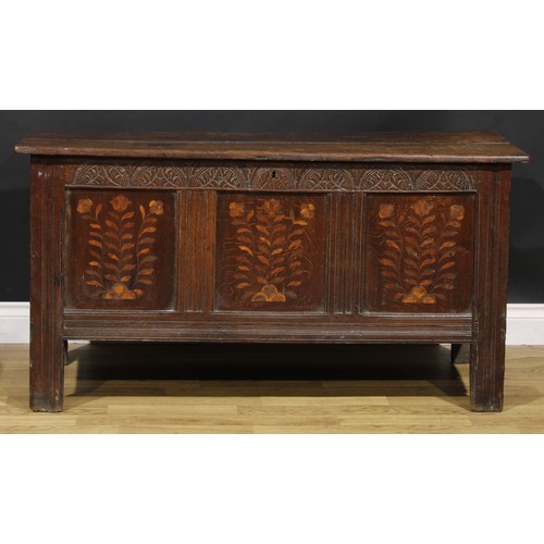 1583 - A Charles II oak blanket chest, the lunette carved frieze above three panels, inlaid in indigenous t... 