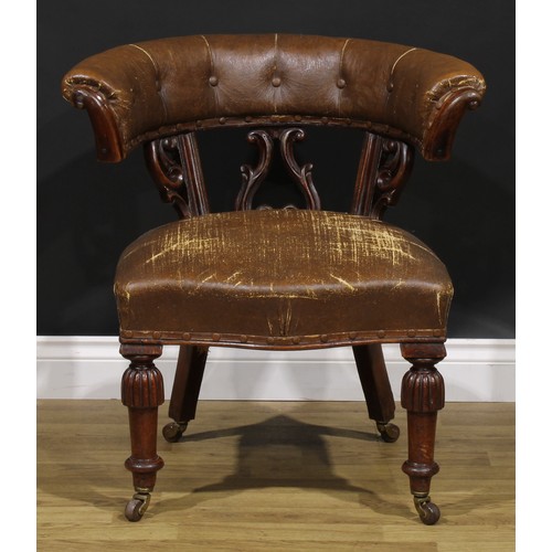 2080 - A Victorian mahogany club or desk chair, stuffed-over upholstery, turned legs, ceramic casters, 73cm... 