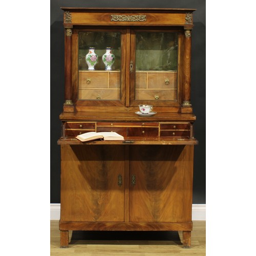 1586 - A French Empire gilt metal mounted mahogany side cabinet, frieze drawer above a pair of glazed doors... 