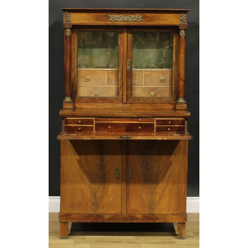 1586 - A French Empire gilt metal mounted mahogany side cabinet, frieze drawer above a pair of glazed doors... 