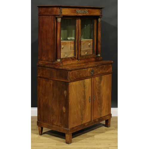 1586 - A French Empire gilt metal mounted mahogany side cabinet, frieze drawer above a pair of glazed doors... 