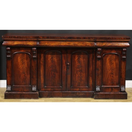 2113 - A Victorian flame mahogany sideboard, rectangular top above three concave moulded frieze drawers, th... 