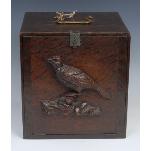 2155 - A late 19th century oak pigeon carrying box, brass handle, the fall front carved and applied with a ... 