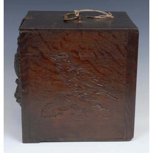 2155 - A late 19th century oak pigeon carrying box, brass handle, the fall front carved and applied with a ... 