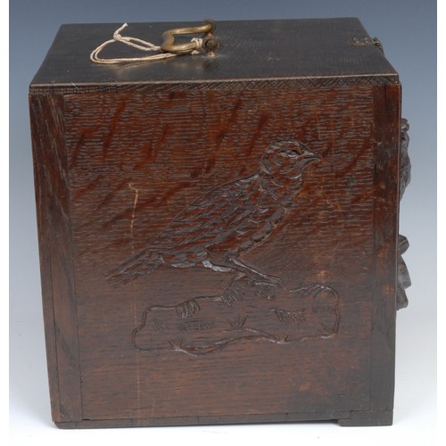 2155 - A late 19th century oak pigeon carrying box, brass handle, the fall front carved and applied with a ... 