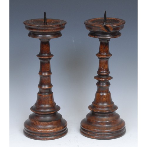 2156 - A pair of 17th century style turned oak pricket candlesticks, 32cm high