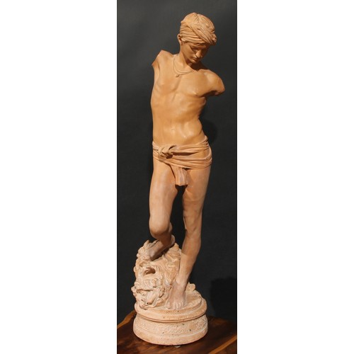 2166 - After the Antique, a terracotta figure, Young David, his foot on the head of Goliath, 89cm high