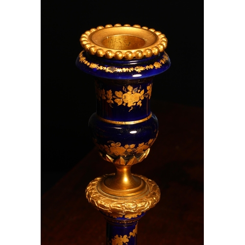 2167 - A pair of 19th century French gilt metal mounted enamel table candlesticks, decorated with bands of ... 