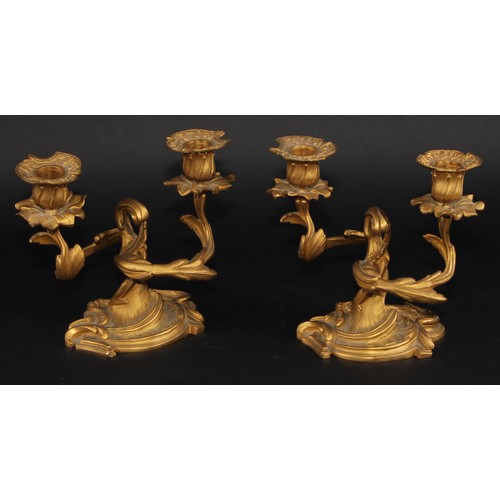 2163 - A pair of 19th century Rococo Revival gilt bronze two-light candelabra, cast throughout with scrolli... 