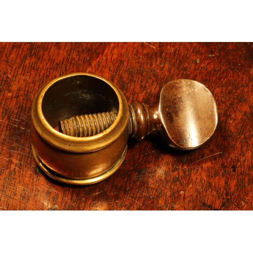 1131 - Nutcrackers - an 18th century brass screw-action pocket nutcracker, the ring shaped receptacle 3cm d... 