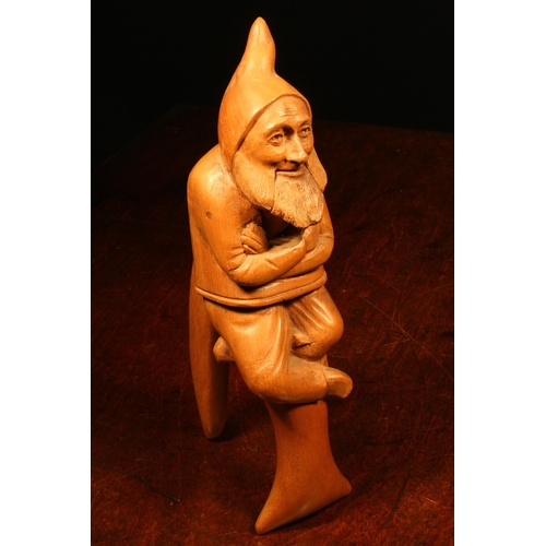 1092 - Nutcrackers - a Black Forest novelty lever-action nut cracker, carved as a gnome, full length, seate... 