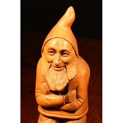 1092 - Nutcrackers - a Black Forest novelty lever-action nut cracker, carved as a gnome, full length, seate... 