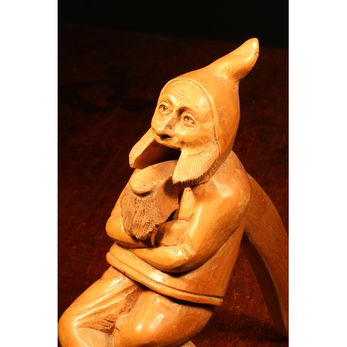 1092 - Nutcrackers - a Black Forest novelty lever-action nut cracker, carved as a gnome, full length, seate... 