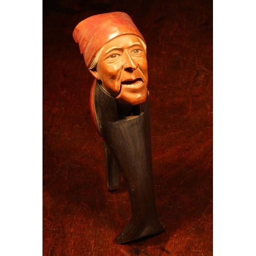 1083 - Nutcrackers - a Black Forest novelty lever-action nut cracker, carved and painted as a gentleman wea... 