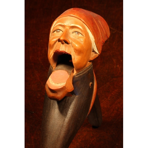 1083 - Nutcrackers - a Black Forest novelty lever-action nut cracker, carved and painted as a gentleman wea... 