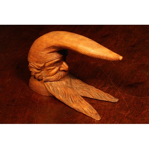 1113 - Nutcrackers - a Black Forest novelty table top lever-action nut cracker, carved as the head of a gno... 