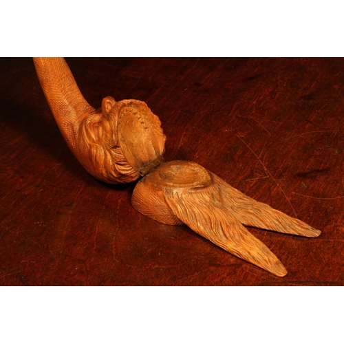 1113 - Nutcrackers - a Black Forest novelty table top lever-action nut cracker, carved as the head of a gno... 