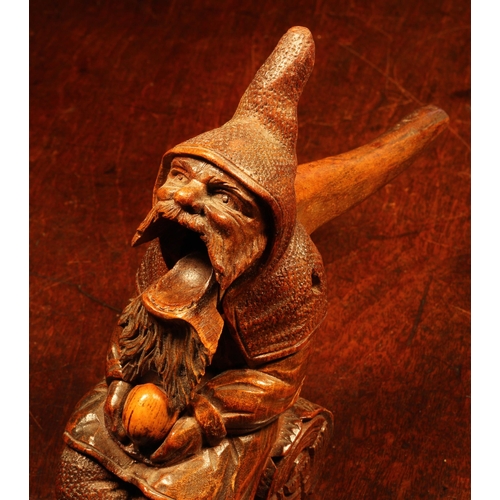 1110 - Nutcrackers - a Black Forest novelty table top lever-action nut cracker, carved as a bearded gnome s... 