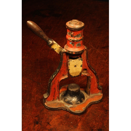 1128 - Nutcrackers - a Victorian cast iron mechanical table top nut cracker, the lever-operated mechanism w... 