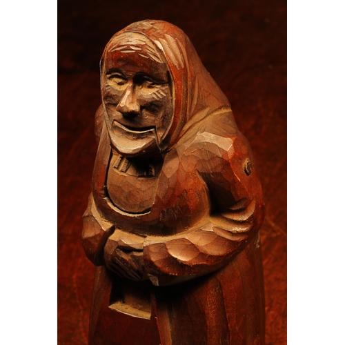 1094 - Nutcrackers - a Black Forest novelty lever-action nut cracker, carved as an elderly woman, she stand... 