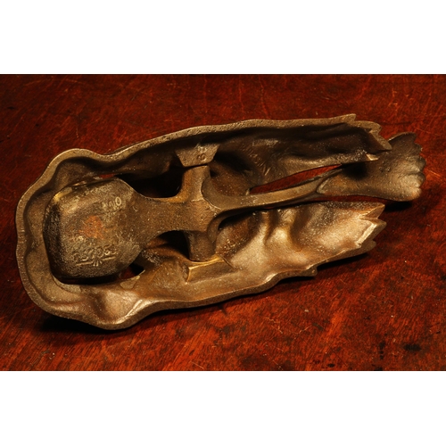 1156 - Nutcrackers - an early 20th century cast iron table top lever-action nut cracker, as a hippopotamus,... 