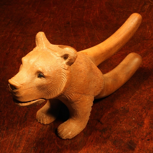 1063 - Nutcrackers - a  Black Forest novelty lever-action nut cracker, carved as a bear, head and forelegs,... 