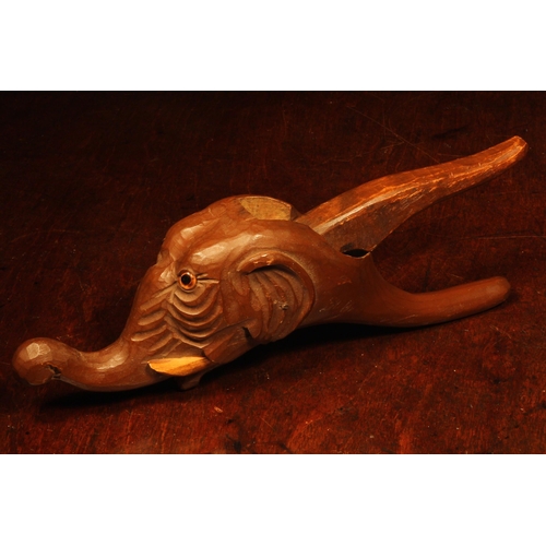 1099 - Nutcrackers - a Black Forest novelty lever-action nut cracker, carved as the head of an elephant, 26... 