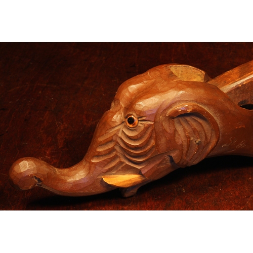 1099 - Nutcrackers - a Black Forest novelty lever-action nut cracker, carved as the head of an elephant, 26... 