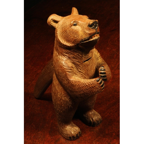 1079 - Nutcrackers - a Black Forest novelty lever-action nut cracker, as a bear, standing, full length, pai... 