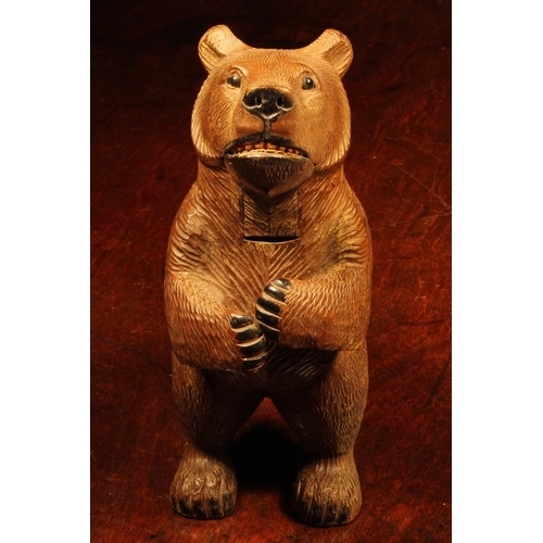 1079 - Nutcrackers - a Black Forest novelty lever-action nut cracker, as a bear, standing, full length, pai... 