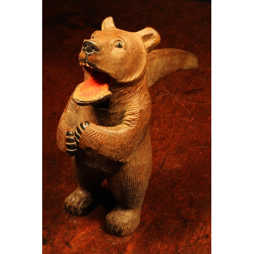 1079 - Nutcrackers - a Black Forest novelty lever-action nut cracker, as a bear, standing, full length, pai... 