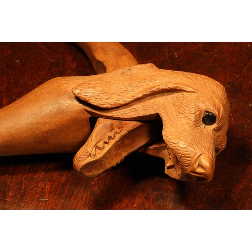 1097 - Nutcrackers - a Black Forest novelty lever-action nut cracker, carved as the head of a dog, glass ey... 