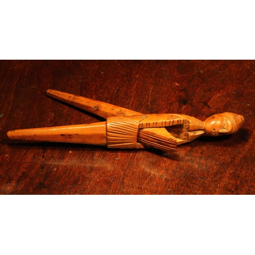 1144 - Nutcrackers - an early 18th century French boxwood figural lever-action nut cracker, of slender prop... 