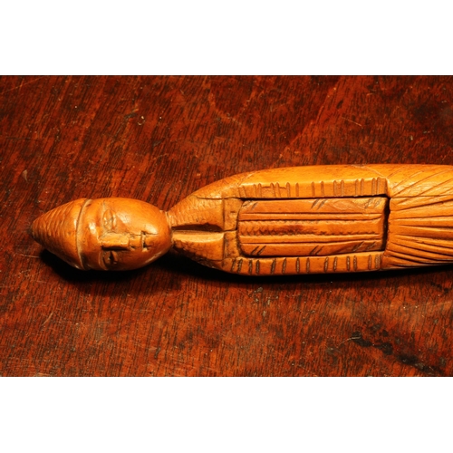 1144 - Nutcrackers - an early 18th century French boxwood figural lever-action nut cracker, of slender prop... 