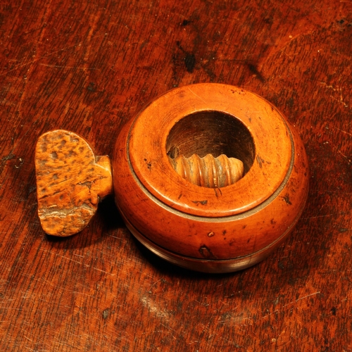 1152 - Nutcrackers - an early 19th century boxwood ring shaped screw-action pocket nut cracker, 6cm diam, c... 