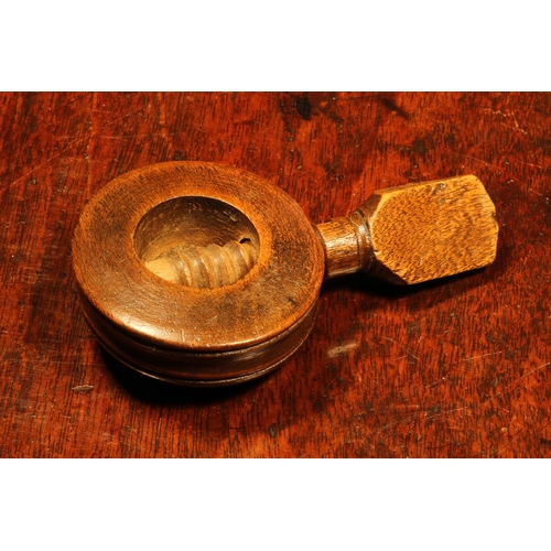 1149 - Nutcrackers - an early 19th century boxwood circular screw-action pocket nut cracker, enclosed chamb... 