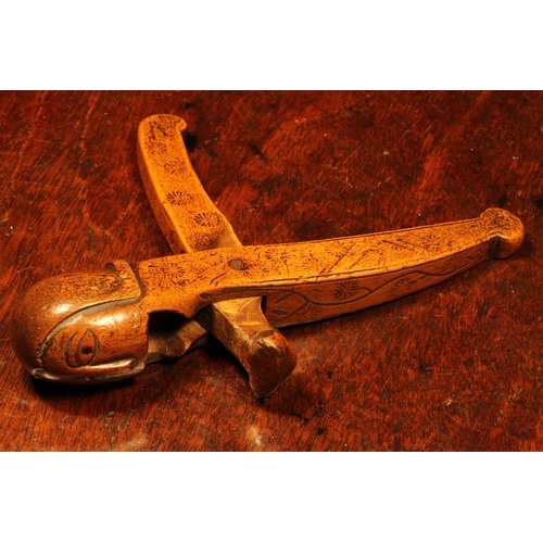 1065 - Nutcrackers - a 17th century boxwood figural lever-action nut cracker, carved as the head of a man, ... 