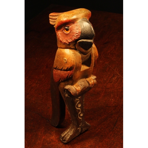 1061 - Nut Crackers - a Black Forest novelty lever-action nut cracker, carved as a parrot, glass eyes, pain... 